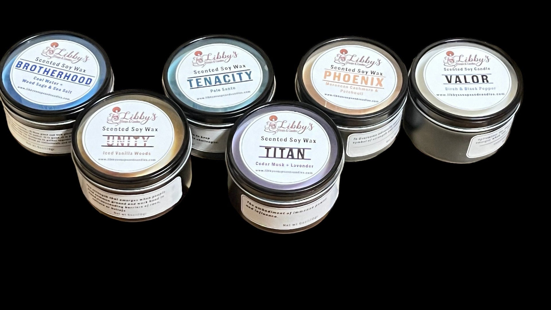 Scented Soy Candles in a black tin with a see through lid. Each container holds 6 ounces of wax with a single cotton wick.