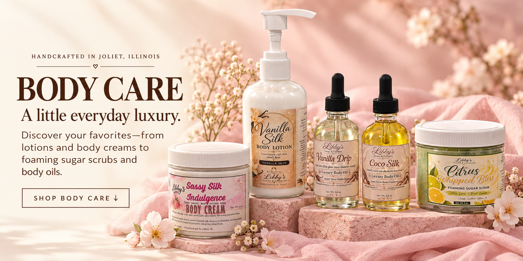 Libby's Vanilla Silk lotion, Sassy Silk Indulgence body cream, Citrus Whipped Bliss scrub, Vanilla Drip and Coco Silk body oils on blush pink risers